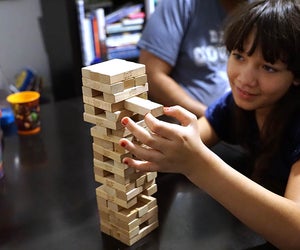 Pull out a block, place it on top but don't let the tower fall in the fun and challenging Jenga.  Photo by Jody Mercier