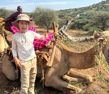 Embrace the slow rhythm of a camel ride on a safari adventure. Photo by Diana Kim